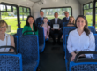staff, premier, council on the bus