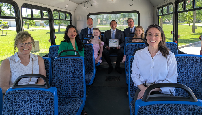 staff, premier, council on the bus